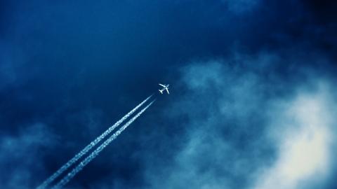 Airplane in the blue sky with clouds