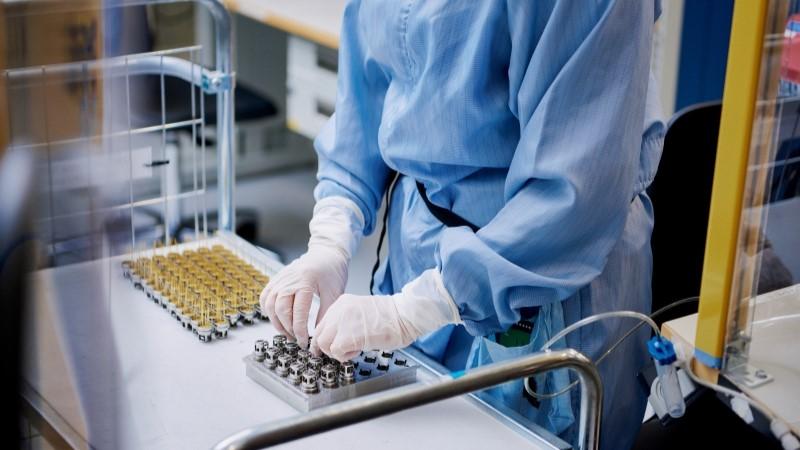 Employee working with components in Vaisala cleanroom