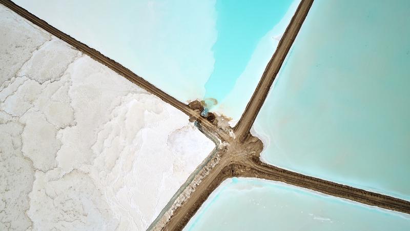 Birds eye view looking straight down on lithium mining ponds in the desert